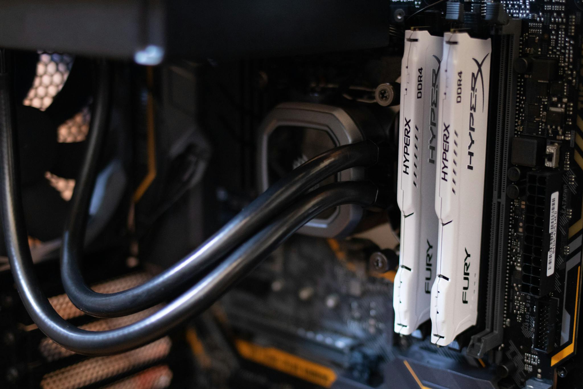 Detailed close-up of computer components including RAM and cables inside a server or high-performance PC.